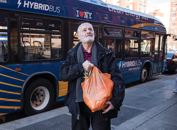 A man carrying an orange bag. lsgp_60-70.jpg